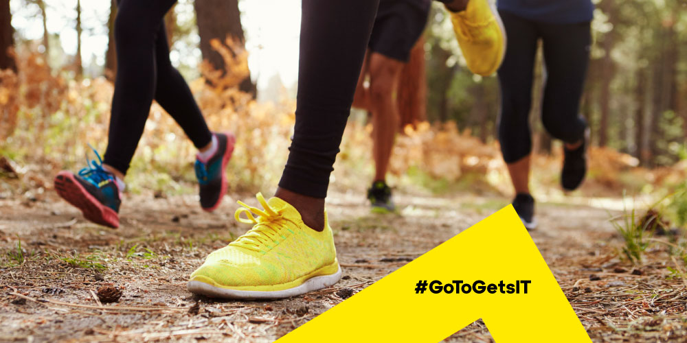 Close up image of four sets of runners’ feet on a wooded trail, representing the fast evolution of remote support and the need to support non-connected devices remotely