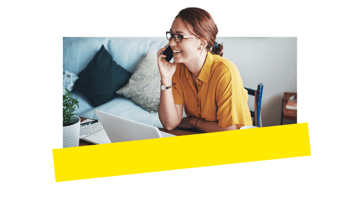 An employee laughing and using VOIP on her personal iphone.