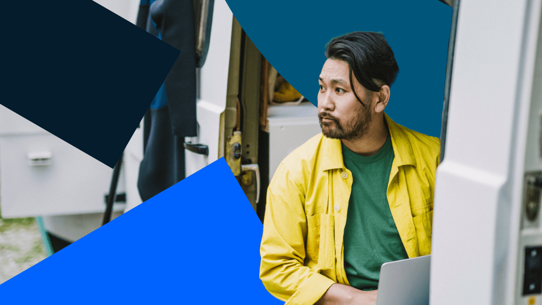 Remote employee in yellow shirt working from his van while on a roadtrip.